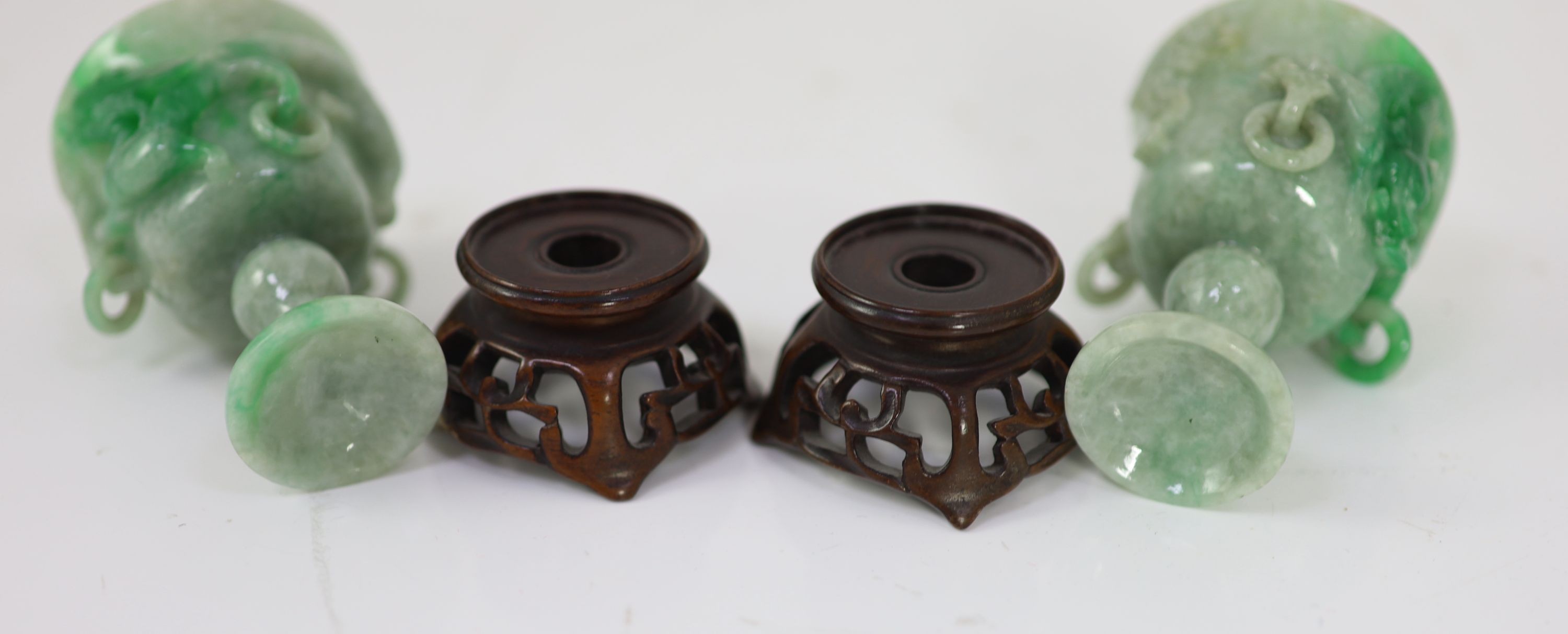 A pair of Chinese small jadeite stem cups, 20th century, 7.2cm high, carved wood stands